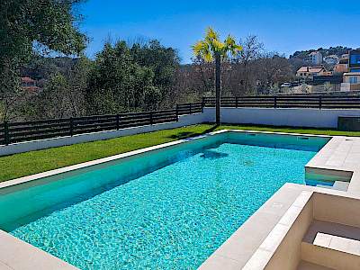 Vanjski bazen okružen zelenim travnjakom i modernom ogradom u Rovinjskom Selu, Istra